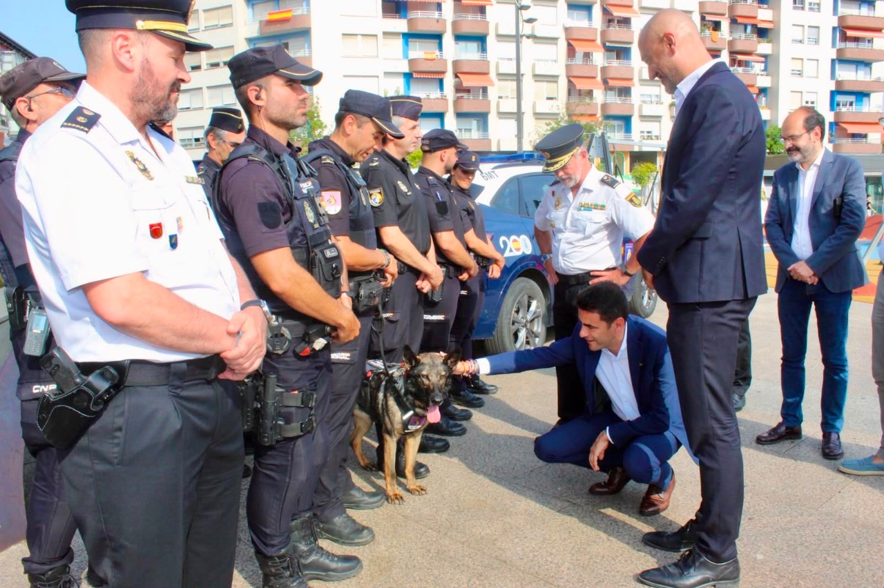 El delegado del Gobierno saluda a un perro policía durante el acto de presentación del refuerzo policía